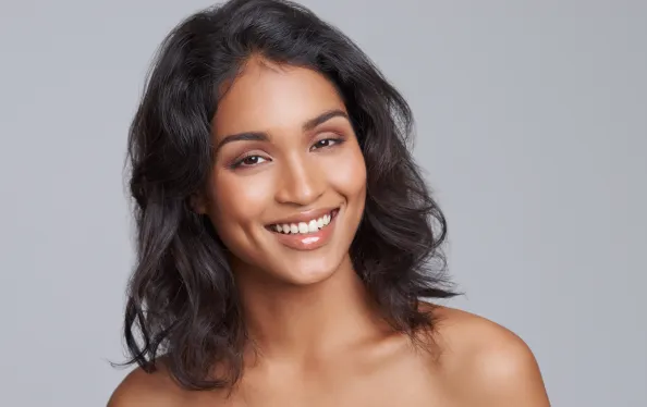 Portrait, beauty and hair with a woman in studio on a gray background for natural haircare treatment